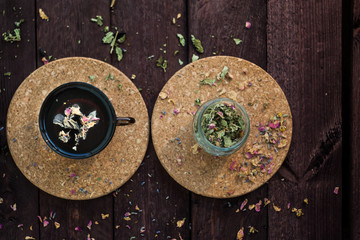 Obraz na płótnie Canvas Brewed delicious herbal tea on a wooden background