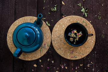 Brewed delicious herbal tea on a wooden background
