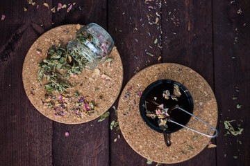 Brewed delicious herbal tea on a wooden background