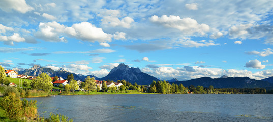 panoramic view of the beautiful Hopfensee lake with the Alps in the background