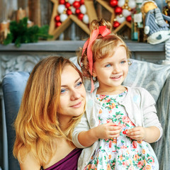 Young mother with child Christmas morning. Concept of Merry Chri