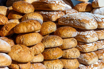 Fototapeta na wymiar Assortment of different types of breads for sale on the market.