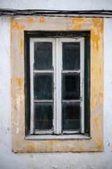 Obraz na płótnie Canvas old window of abandoned house in ruins