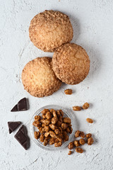caramelized chocolate peanuts and pastries on white rustic backg