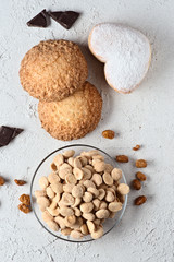 chocolate almonds and pastries on white rustic background