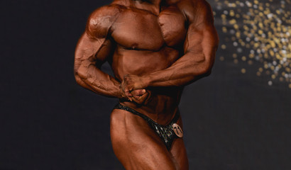 Fototapeta na wymiar bodybuilder posing. Beautiful sporty guy male power. Fitness muscled man