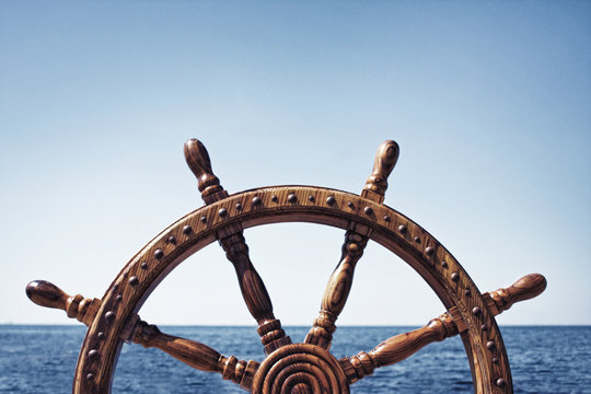 Fototapeta Old Vintage Wooden Helm Wheel on sea background