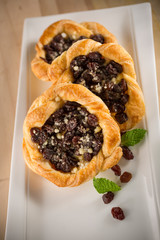 Raisin bun, homemade bakery and raisin on white dish, selective focus, copy space