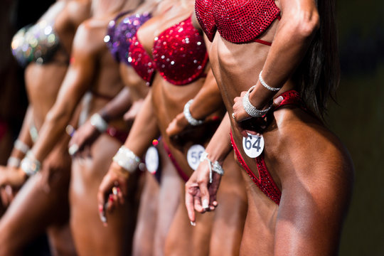 group woman athletes bodybuilders posing most muscular bikini fitness competitions