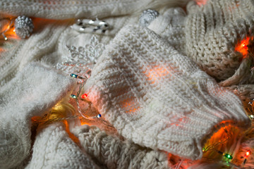 White knitted texture with decor. Soft clothes. Winter season.