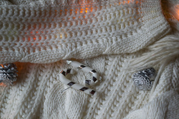 White knitted texture with decor. Soft clothes. Winter season.