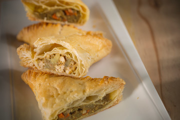 Crispy Chicken curry pie pastry, homemade bakery on white dish, selective focus