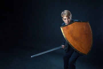 Businessman with shield and sword. Risk management and information protection concept