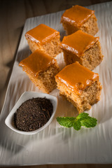 Milk tea cake with dried tea leaves, homemade bakery on white dish, selective focus