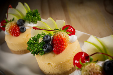 Cheesecake With Fruit Topping, Mixed fruit Cheesecake, Homemade cake on white dish, selective focus