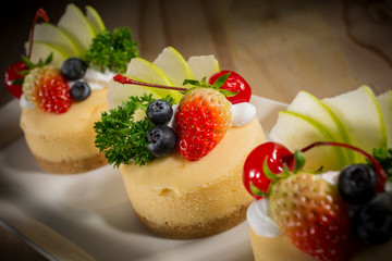 Cheesecake With Fruit Topping, Mixed fruit Cheesecake, Homemade cake on white dish, selective focus