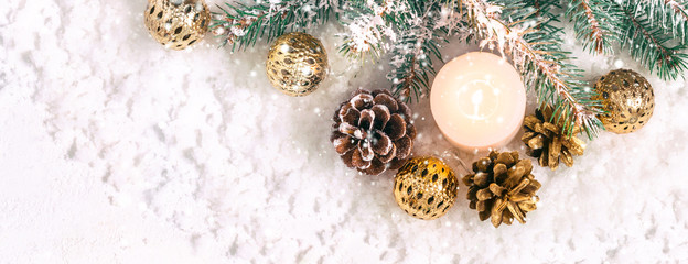 Christmas snow banner. Burning candle, pine branches and cones