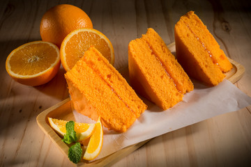 Orange sponge cakes on  wooden background, selective focus