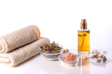 Spa background. Oregano and sea salt, towels and candles. Dried herbs for use in alternative medicine, herbal cosmetic.
