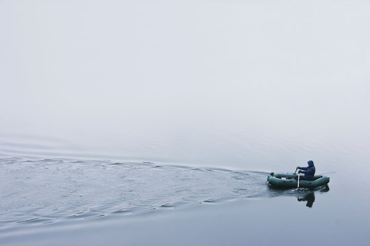 Fisherman in a small boat on the lake