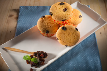 Raisin cupcake, homemade muffins with raisin topping on wooden blackground, selective focus, copy space