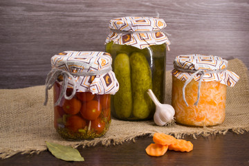 Salted tomatoes, Pickles and salted cabbage in glass jars.