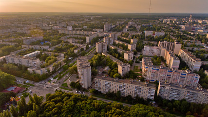 Obraz premium Aerial view of the city at sunset. Beautiful view of urban and nature.