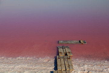 wooden pier pink Lake Shore salt water