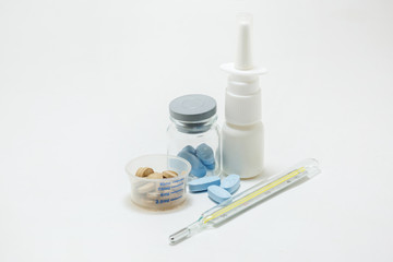 pill packaging and medical supplies nasal spray mercury termometer on white background