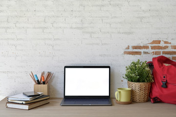 Stylish loft workspace with white screen laptop.