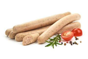 German White Thin sausages with herbs, pepper and tomatoes, isolated on a white background. Close-up.