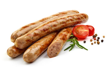 Grilled Nuremberg Sausages with herbs, pepper and tomatoes, isolated on a white background. Close-up.