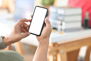Cropped shot male hand holding blank screen mobile phone