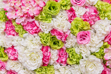 Beautiful multicolored artificial flowers background. flowers decor.