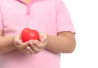 child hands holding red heart isolated