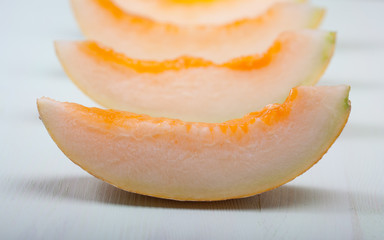 Closeup of sliced melon on a wooden table