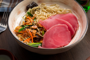 Asian ramen with tuna and noodles in a restaurant