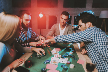 Young Friends Playing Poker on Party at Home.