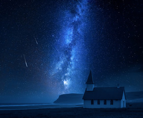 Milky way over small church on the beach, Iceland