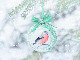 Christmas ball on a Christmas tree in a forest under a snowfall