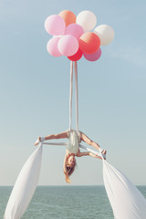 Girl acrobat doing splits in the air.