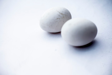 Fototapeta na wymiar Two eggs or ovums isolated on white of hen.
