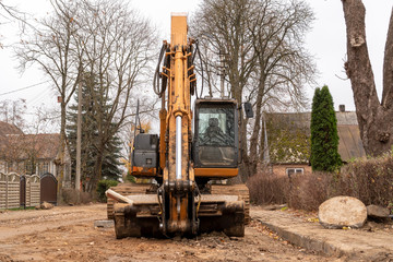 Fototapeta na wymiar Excavator on the street for road repairing