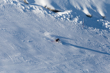 Fototapeta na wymiar Downhill skiing, aerial view. Woman skier in mountains