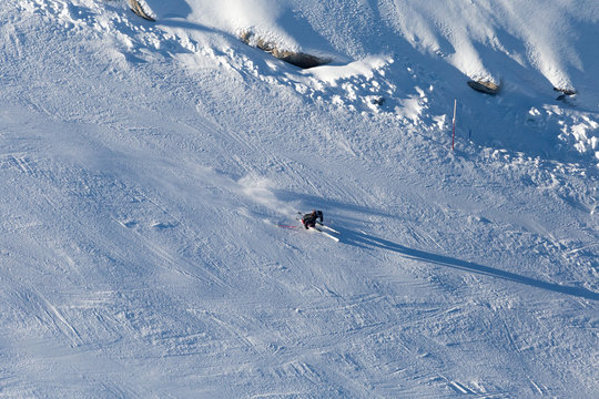Downhill skiing, aerial view. Woman skier in mountains