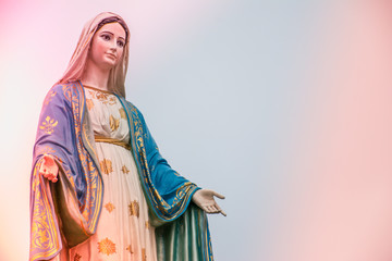 Virgin Mary statue with colourful background, Jesus christ mother. - obrazy, fototapety, plakaty