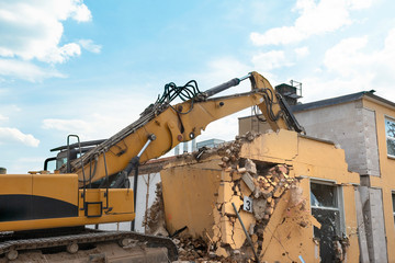 demolition of a house by an excavator