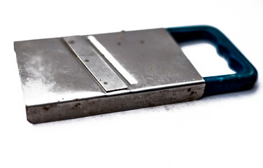 Close up of small slicer used to slice vegetables while making salad,Isolated on white.