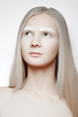 Portrait of a beautiful girl with blond hair and white eyebrows. Interesting makeup