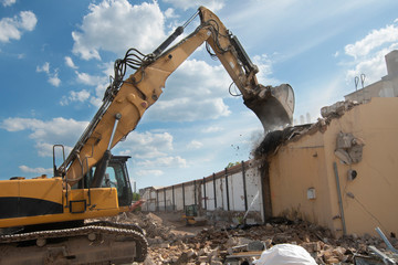 demolition of a house by an excavator